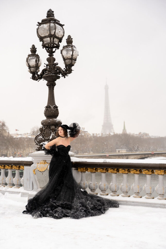 Snow photoshoot in Paris with a black dress