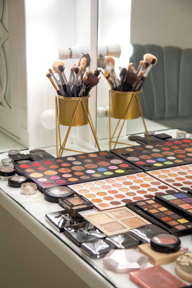Makeup setup for a Paris birthday photoshoot at a hotel room table
