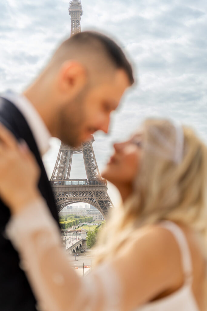 Eiffel Tower couple portrait in Paris with soft background focus, intimate romantic moment