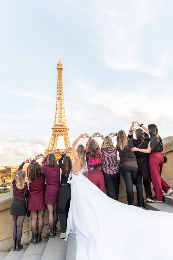 Paris Group Photoshoot with Eiffel Tower, group pose from behind making heart shapes with hands