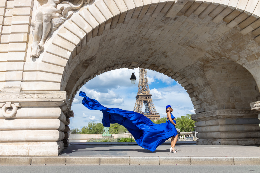 Bir Hakeim bridge photoshoot in Paris, blue flying dress under the arch with Eiffel Tower view