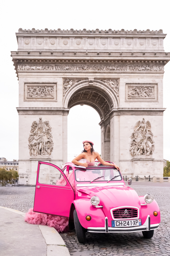 Arc de Triomphe photoshoot in Paris with a pink vintage car, fashion portrait in the morning