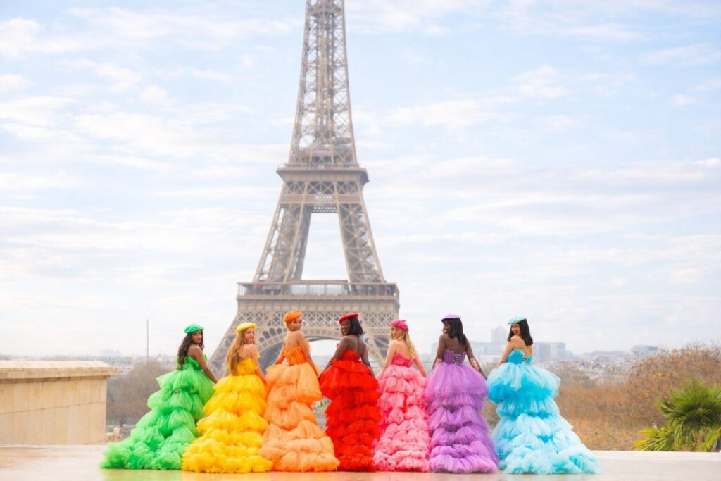 Paris Group Photoshoot at Trocadéro, large group in rainbow dresses with Eiffel Tower background