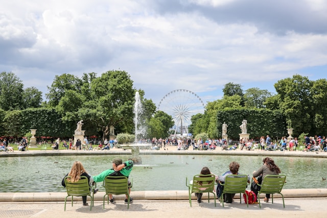 Tuileries Garden Paris photoshoot location with green chairs, fountain and Ferris wheel