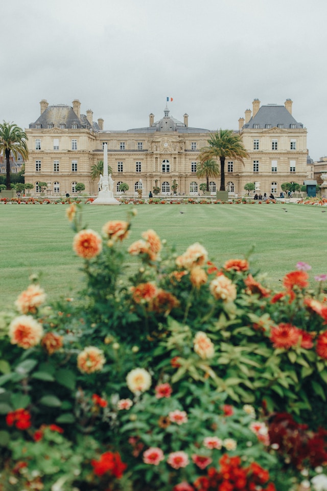 Jardin du Luxembourg Paris photoshoot location with flowers and the Luxembourg Palace