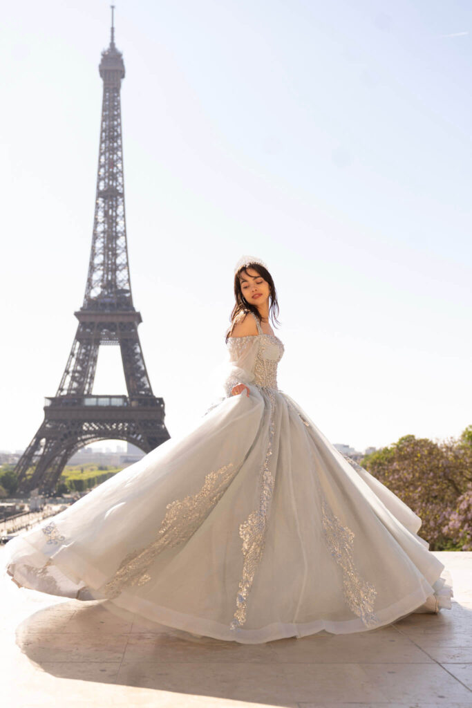 Paris quinceanera photoshoot at the Eiffel Tower with a light blue princess dress